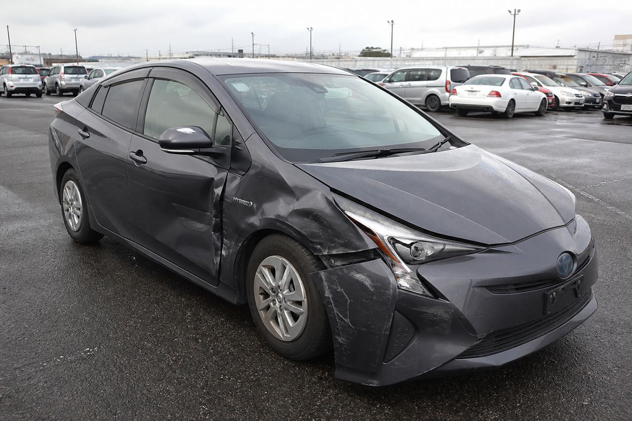 Damaged Toyota Prius at auction — accident history visible on the sheet
